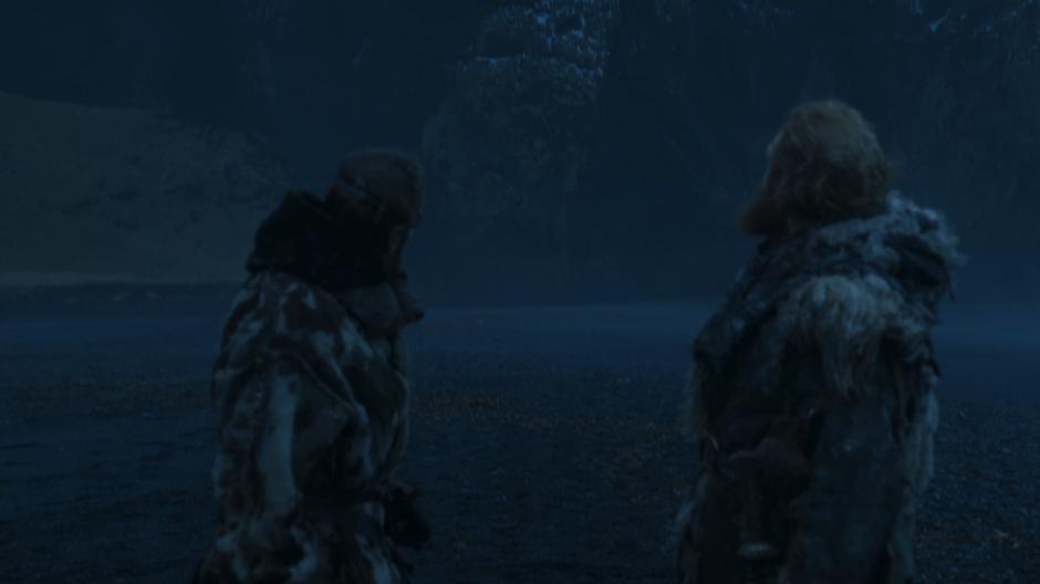 Beric and Tormund look back at the wall as one of the dragon's flies overhead.