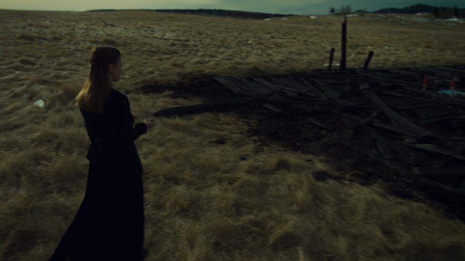 The Widow Beth walks up to the burned ruins of the church with the newly acquired third seal.