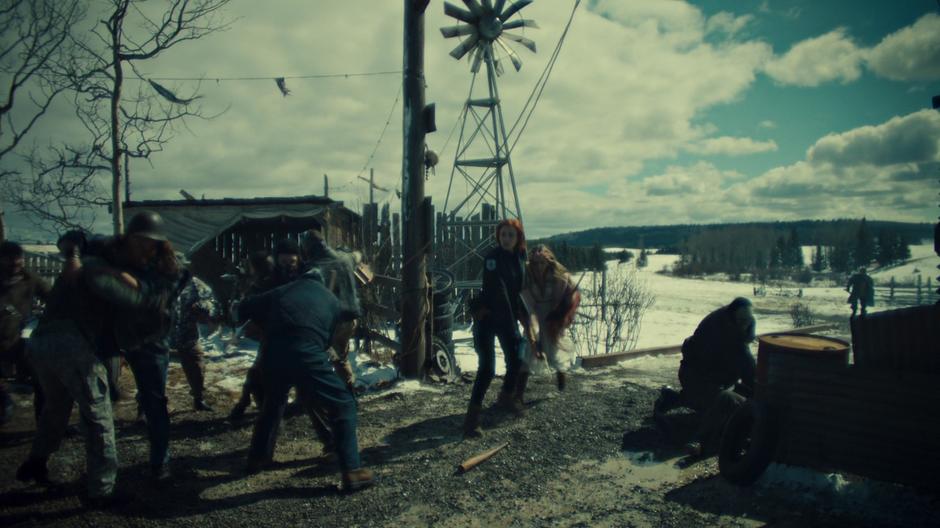 Nicole covers Waverly as they try to run to the barn through the fighting revenants.