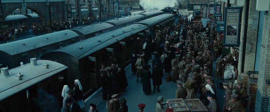 Soldiers crowd the platform as one of the trains begins to pull away.