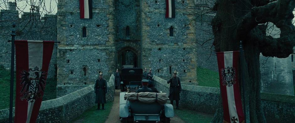 Sameer drives the car with Steve up to the front gate guards at the castle.