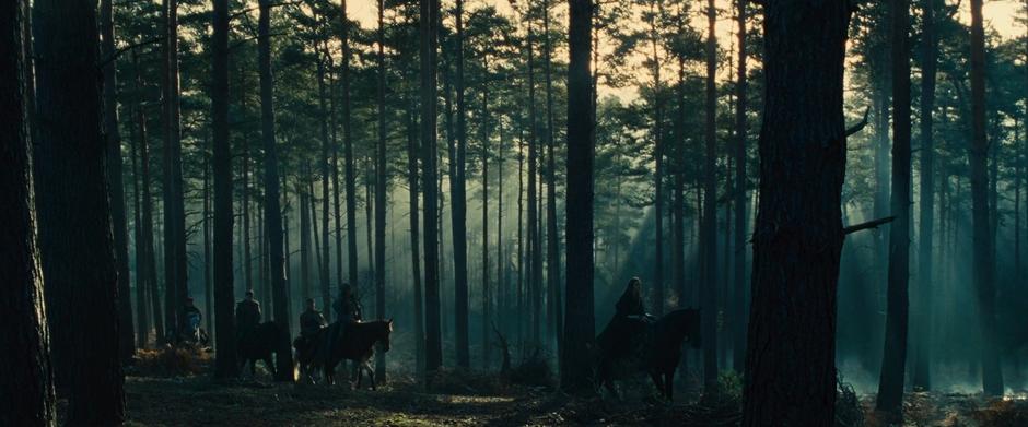 Diana rides at the front of the team heading through the woods.