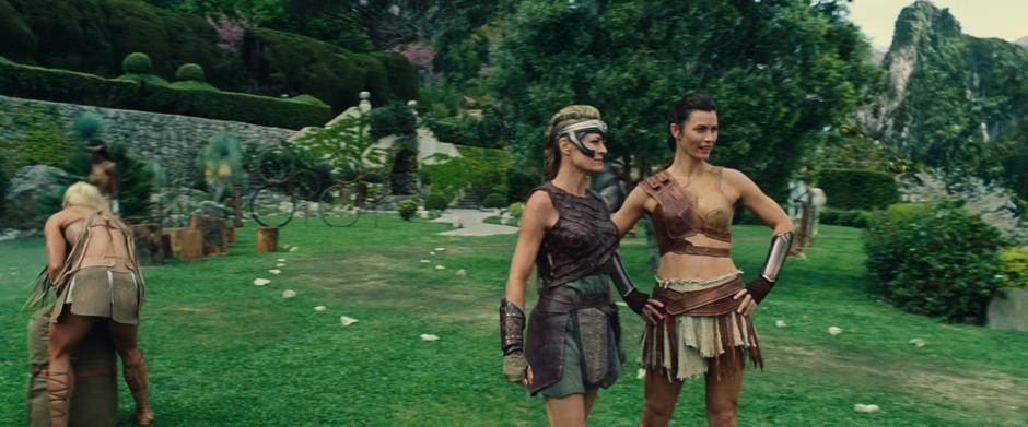 Antiope talks to one of the other Amazons on the training grounds.