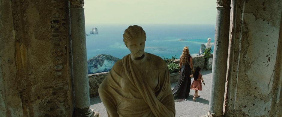 Hippolyta leads Diana out onto the balcony overlooking the sea.