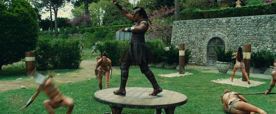 Artemis fights off several other Amazons while standing on a platform in the middle of the grounds.