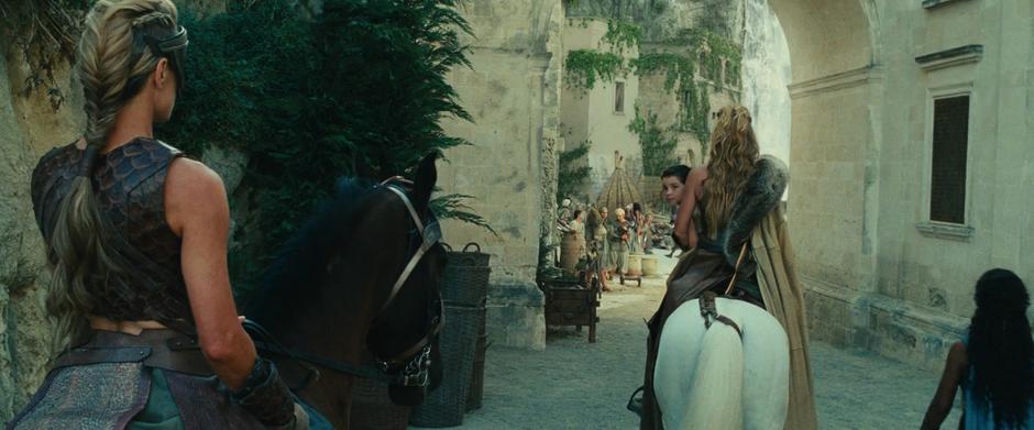 Diana looks back at Antiope as she rides off with her mother.