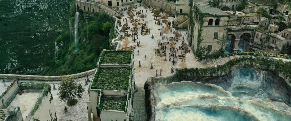 Aerial shot of the market as Diana runs from the stairs.