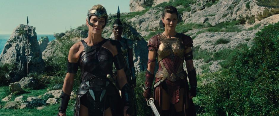 Antiope watches Diana's testing with two other Amazons.