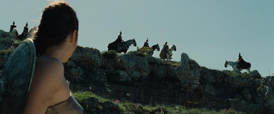 Diana looks up at the hillside where her mother is watching from horseback.