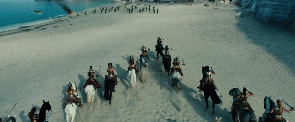 Antiope leads a charge of horses down the beach.