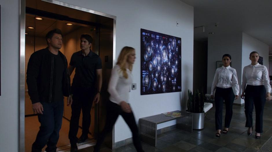 Sara leads Nate and Ray out of the elevator into the Time Bureau offices.
