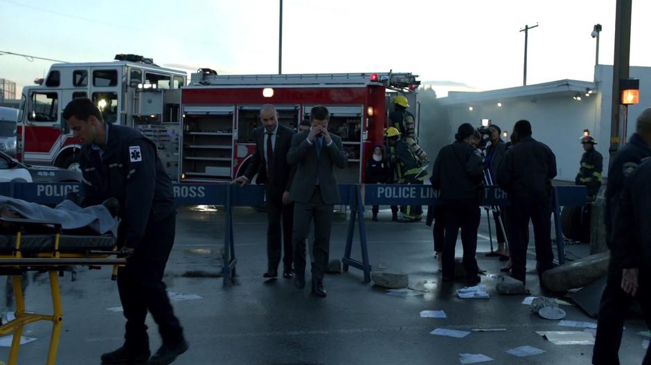 Lance, Rene, and Oliver walk through the police barrier.