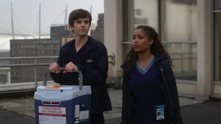 Shaun and Claire walk out onto the roof with the donor liver.