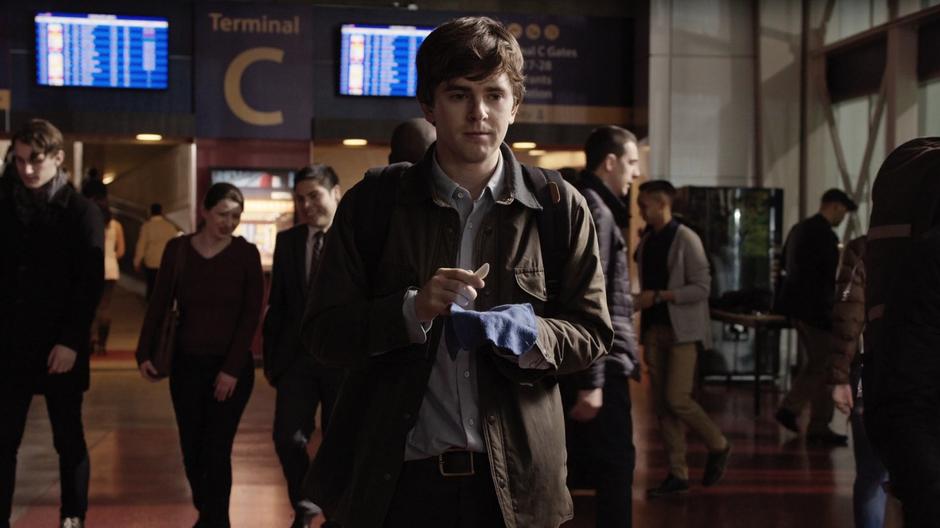 Shaun holds his plastic scalpel while trying to deal with the stress of the airport.