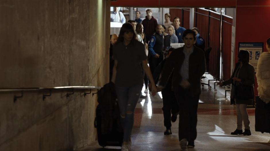 Shaun runs back up to the concourse after grabbing a knife from security.