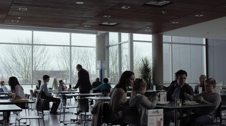 Dr. Glassman sits down at the table in the cafeteria where Shaun is sitting.