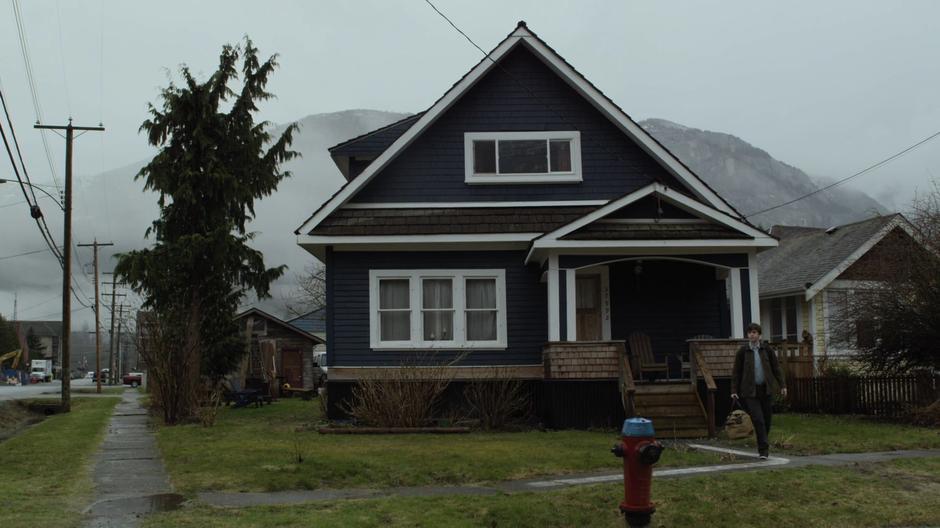 Shaun walks down the pathway out front of his house.