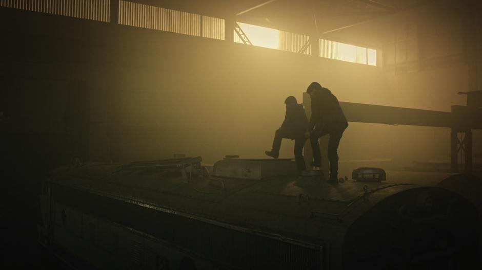 Shaun follows Steve as he climbs across the top of the train.