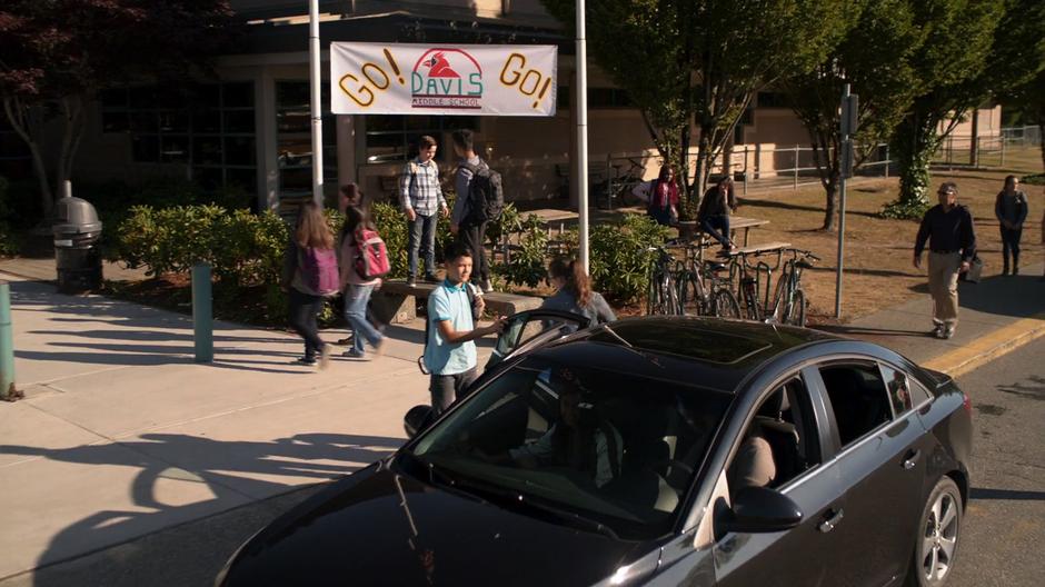 Students are dropped off out front of the school.