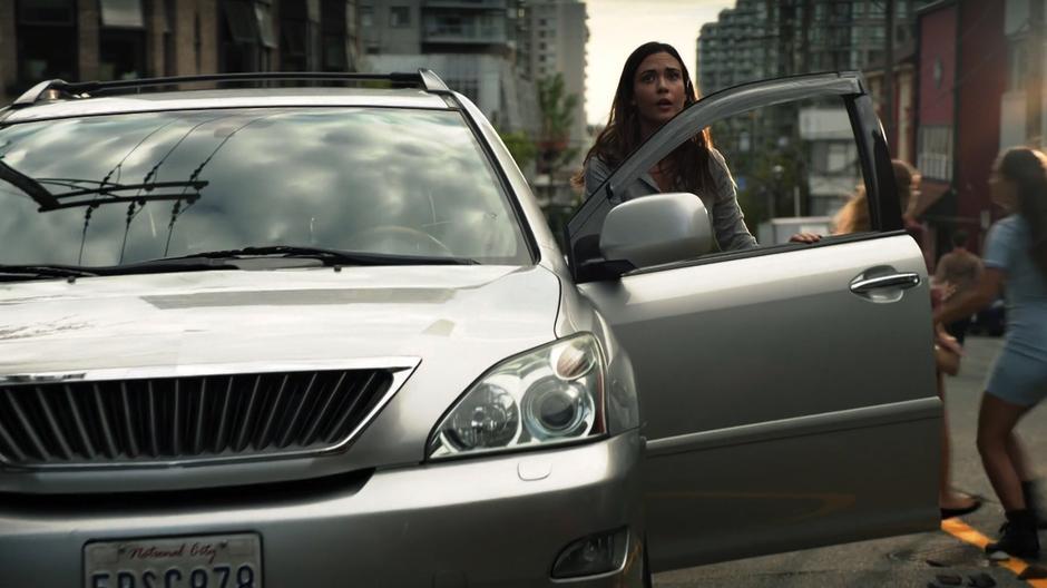 Sam sees her daughter walking through the danger as she exits her car.