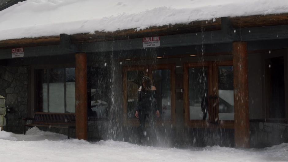 Maze is covered by snow falling from the roof above her.