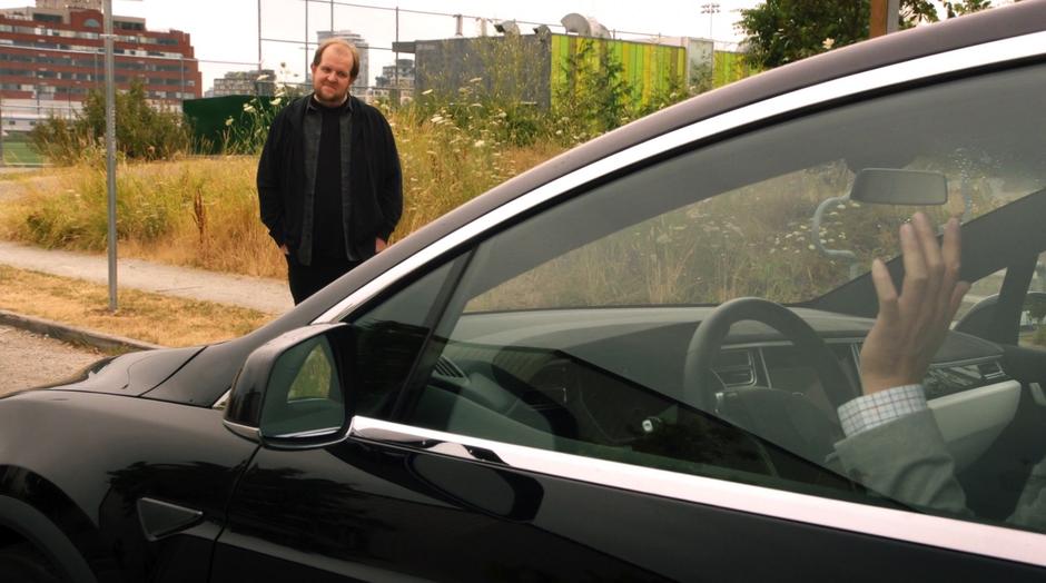 Ramsey Deacon looks at Tim Kwon who is trapped in his car.