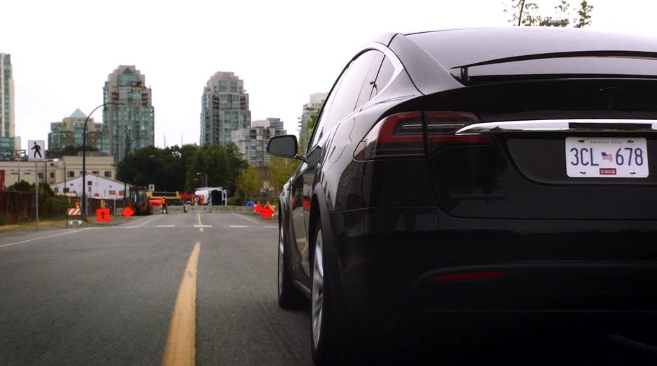 Tim Kwon's car races towards a construction site.