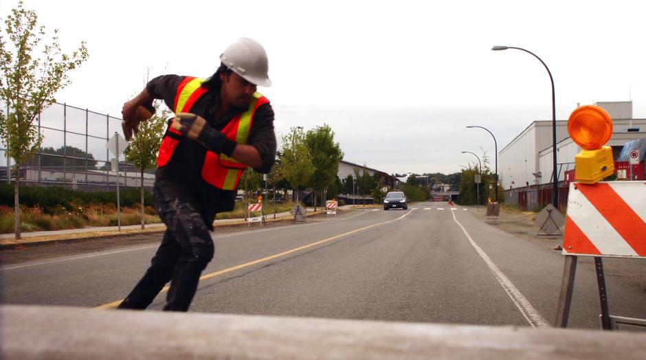 A construction worker runs out of the way as Tim Kwon's drives towards the site.