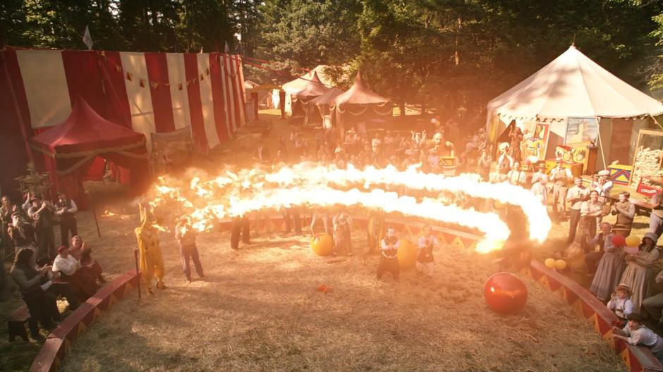 Firestorm flies around above the ring while the crowd looks on in wonder.