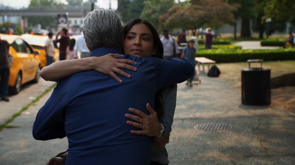 Maggie hugs her father after he gets off the bus.