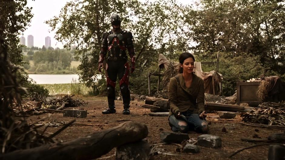 Ray approaches Zari as she is kneeling over the ruins of the sanctuary.