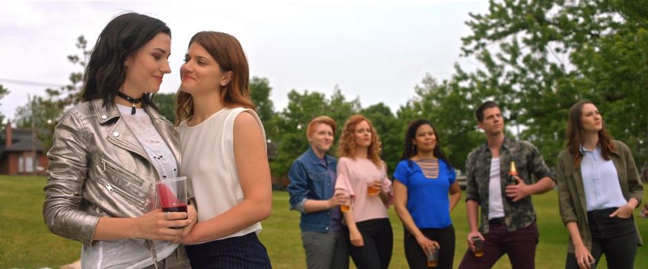 Carmilla and Laura hold each other and stare into each others eyes while the rest o the gang lines up behind looking out at the city.