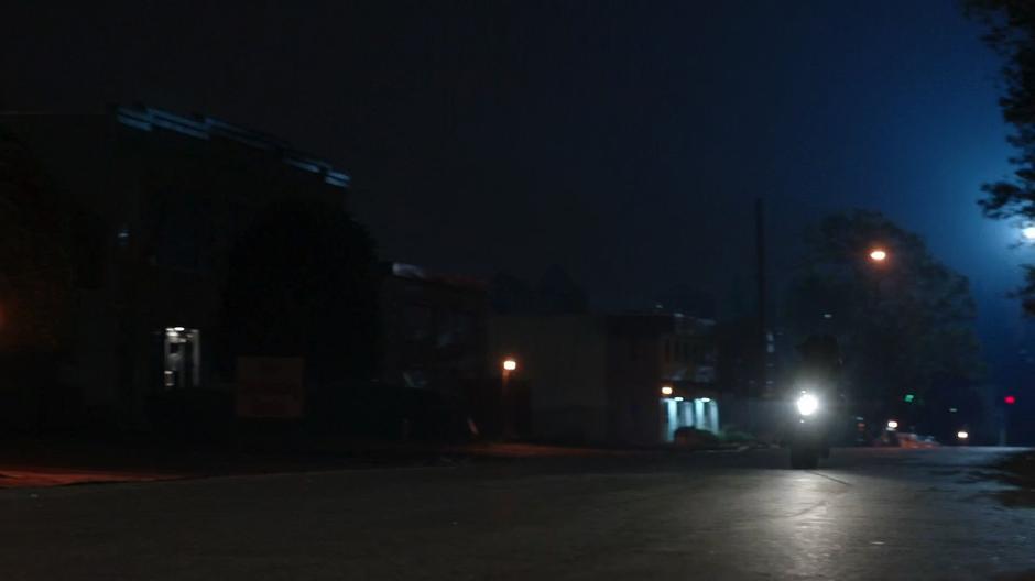 One of the team members rides a motorcycle down the street.