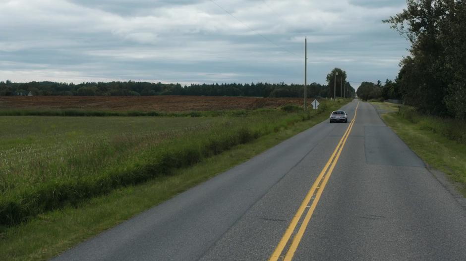 Amanda and Vogel's car drives down the highway.