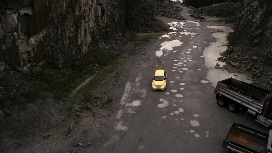 Suzie drives down into the quarry towards the office.