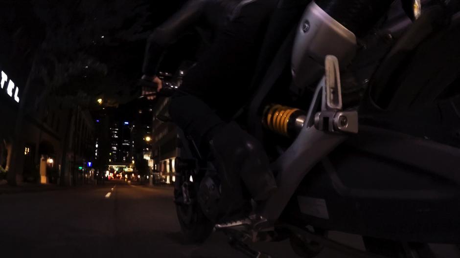 Alex bikes down the street at night.