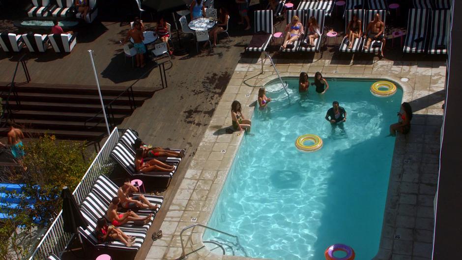 The suspect stands in the pool after being thrown from the roof.