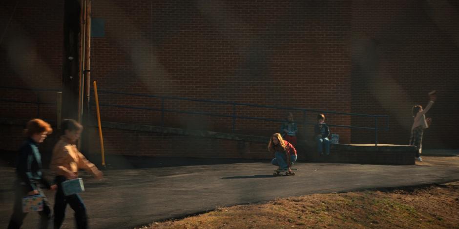 Max skates around school grounds.