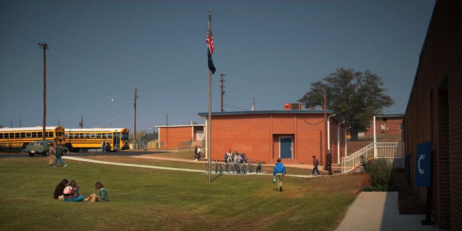 Will is lead out of the school by Principal Coleman to where Joyce waits by the car.