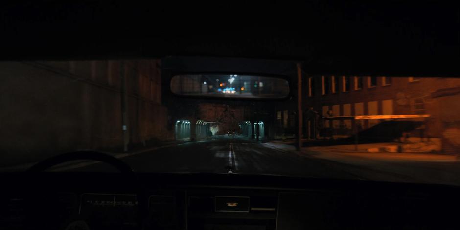 The tunnel appears to collapse in front of the speeding police car.