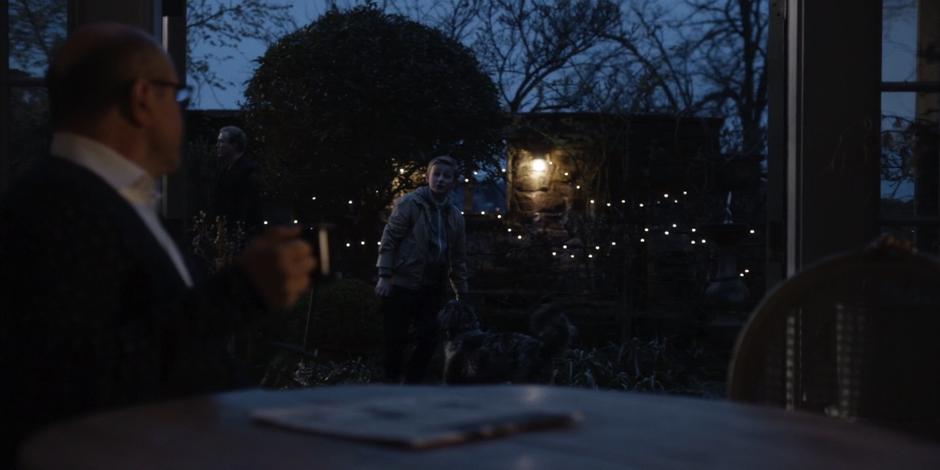 Vincent watches his son play with their dog in the small yard.