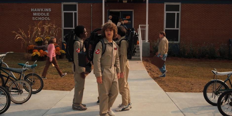 While Lucas, Mike, and Will talk, Dustin notices that no one else came to school wearing costumes.