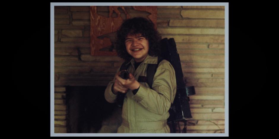 Dustin smiles at the camera in his Ghostbusters costume.