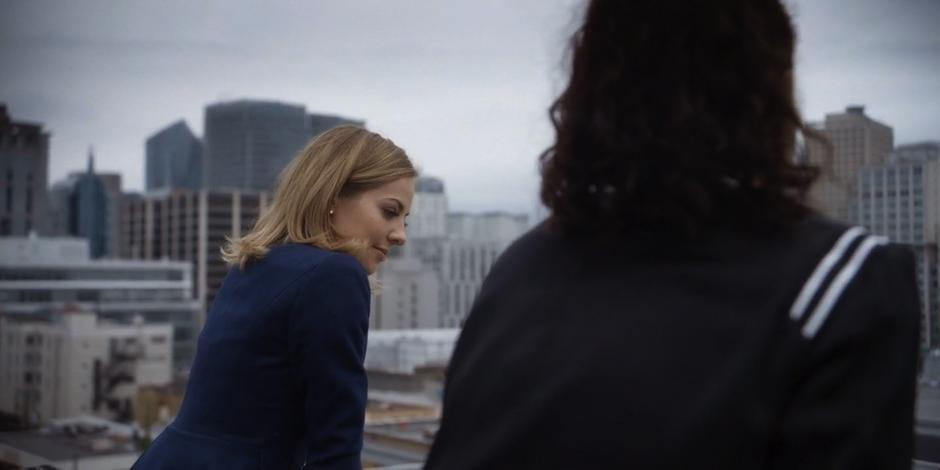 Marcy sits with Carly atop the building.