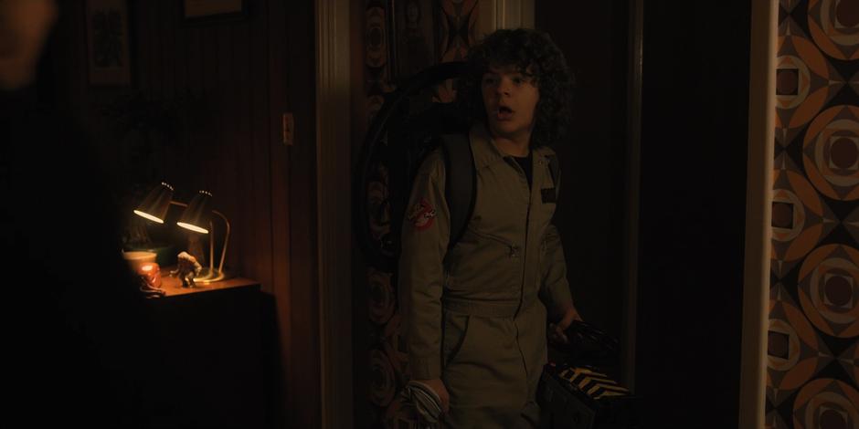 Dustin turns back as his mother approaches him.