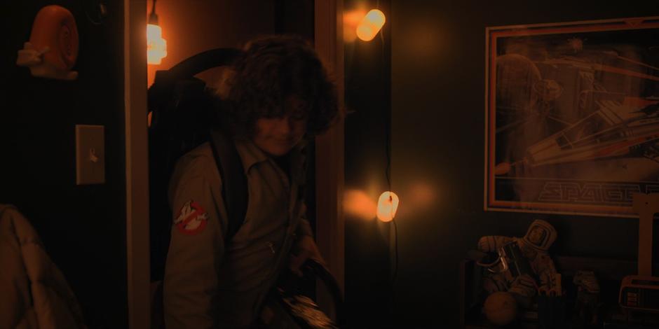 Dustin enters his room with the creature hidden in his Ghost Trap.