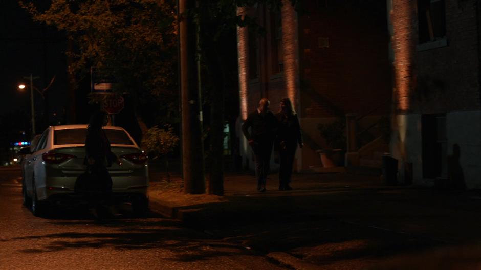 Councilwoman Pollard walks from her car to her apartment building at night.