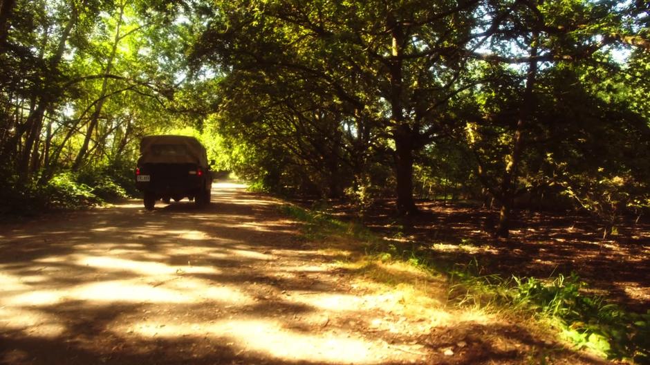 Slade and his son drive down the road in the forest.