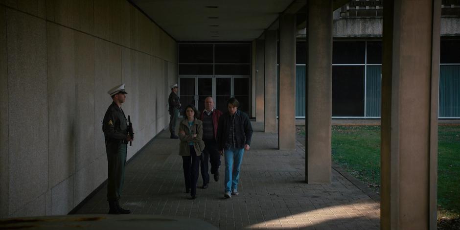 Nancy and Jonathan are escorted out of the lab.