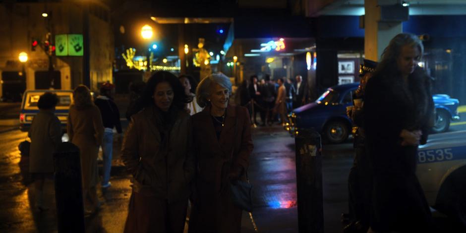 People walk around the street at night.